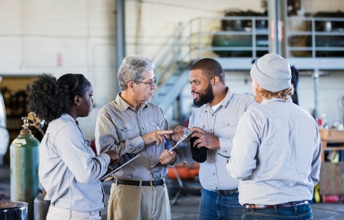 Deskless workers in a warehouse going through training 